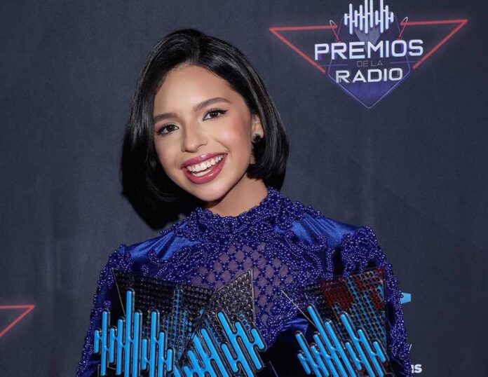 Ángela Aguilar maintains fame as a Mexican American singer who established her career through Regional Mexican music while preserving family musical traditions. Being part of a legendary musical family enabled her to deliver compelling performances with a strong voice that blends traditional music with modern elements. She has crowned Latin music milestones at a young age and has grown as a worldwide sensation in her industry.   Profile Summary  Birth Name:	Ángela Aguilar Álvarez Alcalá Nickname:	La Princesa Del Mariachi, La Princesa Mexicana Nationality:	Mexican-American (dual citizenship) Date of birth:	 October 8, 2003 Age:	21 years old (as of 2025) Astrological Sign:	Libra Religion:	Christianity Ethnicity:	Latino Profession:	Singer Height:	5 feet 5 inches (165 cm) Weight:	55 kg (121 pounds) Natural Hair Color:	Black Natural Eye Color:	Dark Brown Sexual Orientation:	Straight Parents:	 Father: Pepe Aguilar (Singer) Mother: Aneliz Álvarez Alcalá (Philanthropist)  Siblings:	 Brother: Leonardo Aguilar (Singer) Sister: Aneliz Aguilar  Marital Status:	Married Husband:	Christian Nodal (Singer, Songwriter) Net Worth:	$5 million Social Media Profile	Instagram Place of birth:	Los Angeles, California, United States Early Life  The Mexican-American singer Ángela Aguilar came into the world on October 8th of 2003 in Los Angeles California USA. She was born as the child of singer Pepe Aguilar and Aneliz Álvarez-Alcala. Ángela belongs to the Aguilar dynasty which showcases its heritage through her famous grandfather Antonio Aguilar along with her grandmother Flor Silvestre who were famous figures in Mexican music and film.  Since childhood, Ángela spent her days immersed in musical activities that also included performing with her family. She dedicated many years of her early life to shuttling between the United States and Mexico as she simultaneously adopted the cultures while training her singing talent.  In 2025 Ángela Aguilar reaches the age of 21. She measures 165 cm (5 feet 5 inches) tall and carries a weak yet distinguished physique framework. Her captivating looks together with her dramatic eyes and customary Mexican outfits showcase authentic Mexican cultural values.  Family and Relationships   The Aguilar dynasty provided Ángela Aguilar with her birth because this family lives deeply within Mexican music and culture. Throughout his career, Pepe Aguilar has established a position as a Mexican singer-songwriter-producer who made significant contributions to ranchera and mariachi styles of music. Multiple Grammy awards alongside Latin Grammy awards have made Pepe supreme in guiding Ángela's musical development and he teaches her while appearing with her during performances. The silent contributions of Aneliz Álvarez Alcalá to her family life include her philanthropic work and behind-the-scenes support of her family members. While absent from public view, Aneliz teaches her daughter valuable principles of discipline and perseverance.  Ángela maintains a strong relationship with all her elderly siblings. The vocalist Leonardo Aguilar demonstrates musical talent as he plays with his sister Ángela just as he does with his popular Mexican music. Since musical collaboration is their shared interest the siblings have united their talents multiple times. Although she pursues business and social media instead of music Aneliz Aguilar supports Ángela in her life and career. As the descendant of such a distinguished music-oriented family, Ángela extends their musical legacy into the present without losing her personal direction in the industry.  The popular Mexican singer and songwriter Christian Nodal is Ángela Aguilar's married husband at present. Their combined dedication to music together with professional Latin music collaborations has made the couple recognized throughout the industry. Their romantic relationship receives fan approval while they show continuous backing for each other's professional music goals. The Latin music world admires Christian Nodal and Ángela Aguilar as an influential duo since he presents songs in the Mexican regional genre alongside her ranchera music traditions.  Career Details about Angela Aguilar  Ángela performed in her first professional singing event at a young age when she joined her father in stage concerts. Her brother Leonardo Aguilar joined her in 2012 to produce Nueva Tradición featuring four songs penned separately by each artist.  Her first true musical breakthrough came through the release of Primero Soy Mexicana in 2018 an album dedicated to traditional ranchera music. The album received substantial commercial success at the same time it earned her a nomination for Best Ranchero/Mariachi Album at the Latin Grammy Awards. Her unique vocal powers together with her modern adaptation of traditional Mexican music earned widespread praise both from critics and general audiences.  Ángela appeared on the Latin Grammy stage in 2019 to perform a tribute to traditional Mexican music which won global audience approval. The public made La Llorona and Cielo Rojo two of her most popular songs through widespread adoption. Her later album Mexicana Enamorada (2021) allowed viewers to witness the artistic development of the singer. She achieved Latin music chart success through her hit song Dime Cómo Quieres which she released with Christian Nodal. The recognition of her mariachi and ranchera work through awards belongs to Ángela Aguilar along with the multiple awards and honors she received.  Net Worth   Ángela Aguilar currently holds an estimated net worth of $5 million according to calculations from 2025. The singer derives most of her earnings from Music purchases along with streaming revenue together with performing live shows running tours securing various brand partnerships and selling product merchandise. The artist enjoys notable recognition across her social media accounts particularly Instagram TikTok and YouTube because she regularly posts about her music and personal moments for her fans to see.  FAQs About Angela Aguilar Q: Who is Angela Aguilar?  A: She is a rising star in the world of regional Mexican music, specializing in mariachi and ranchera genres.  Q: What is Angela Aguilar's age?  A: She is 21 years old.  Q: How tall is Angela Aguilar?  A: Her height is 5 feet 5 inches.  Conclusion   Rodri Gómez stands out as a notable figure in urban music thanks to his vast singing skills and outstanding talent. Her cultural dedication and outstanding vocals together with her influential family heritage allow Ángela Aguilar to revitalize Regional Mexican music for upcoming listeners. Audiences are excited to experience what this gifted up-and-coming performer has in store for them to display in upcoming years. Ángela Aguilar maintains fame as a Mexican American singer who established her career through Regional Mexican music while preserving family musical traditions. Being part of a legendary musical family enabled her to deliver compelling performances with a strong voice that blends traditional music with modern elements. She has crowned Latin music milestones at a young age and has grown as a worldwide sensation in her industry.  Profile Summary Birth Name: Ángela Aguilar Álvarez Alcalá Nickname: La Princesa Del Mariachi, La Princesa Mexicana Nationality: Mexican-American (dual citizenship) Date of birth:  October 8, 2003 Age: 21 years old (as of 2025) Astrological Sign: Libra Religion: Christianity Ethnicity: Latino Profession: Singer Height: 5 feet 5 inches (165 cm) Weight: 55 kg (121 pounds) Natural Hair Color: Black Natural Eye Color: Dark Brown Sexual Orientation: Straight Parents: Father: Pepe Aguilar (Singer) Mother: Aneliz Álvarez Alcalá (Philanthropist) Siblings: Brother: Leonardo Aguilar (Singer) Sister: Aneliz Aguilar Marital Status: Married Husband: Christian Nodal (Singer, Songwriter) Net Worth: $5 million Social Media Profile Instagram Place of birth: Los Angeles, California, United States Early Life The Mexican-American singer Ángela Aguilar came into the world on October 8th of 2003 in Los Angeles California USA. She was born as the child of singer Pepe Aguilar and Aneliz Álvarez-Alcala. Ángela belongs to the Aguilar dynasty which showcases its heritage through her famous grandfather Antonio Aguilar along with her grandmother Flor Silvestre who were famous figures in Mexican music and film. Since childhood, Ángela spent her days immersed in musical activities that also included performing with her family. She dedicated many years of her early life to shuttling between the United States and Mexico as she simultaneously adopted the cultures while training her singing talent. In 2025 Ángela Aguilar reaches the age of 21. She measures 165 cm (5 feet 5 inches) tall and carries a weak yet distinguished physique framework. Her captivating looks together with her dramatic eyes and customary Mexican outfits showcase authentic Mexican cultural values. Family and Relationships  The Aguilar dynasty provided Ángela Aguilar with her birth because this family lives deeply within Mexican music and culture. Throughout his career, Pepe Aguilar has established a position as a Mexican singer-songwriter-producer who made significant contributions to ranchera and mariachi styles of music. Multiple Grammy awards alongside Latin Grammy awards have made Pepe supreme in guiding Ángela's musical development and he teaches her while appearing with her during performances. The silent contributions of Aneliz Álvarez Alcalá to her family life include her philanthropic work and behind-the-scenes support of her family members. While absent from public view, Aneliz teaches her daughter valuable principles of discipline and perseverance. Ángela maintains a strong relationship with all her elderly siblings. The vocalist Leonardo Aguilar demonstrates musical talent as he plays with his sister Ángela just as he does with his popular Mexican music. Since musical collaboration is their shared interest the siblings have united their talents multiple times. Although she pursues business and social media instead of music Aneliz Aguilar supports Ángela in her life and career. As the descendant of such a distinguished music-oriented family, Ángela extends their musical legacy into the present without losing her personal direction in the industry. The popular Mexican singer and songwriter Christian Nodal is Ángela Aguilar's married husband at present. Their combined dedication to music together with professional Latin music collaborations has made the couple recognized throughout the industry. Their romantic relationship receives fan approval while they show continuous backing for each other's professional music goals. The Latin music world admires Christian Nodal and Ángela Aguilar as an influential duo since he presents songs in the Mexican regional genre alongside her ranchera music traditions. Career Details about Angela Aguilar Ángela performed in her first professional singing event at a young age when she joined her father in stage concerts. Her brother Leonardo Aguilar joined her in 2012 to produce Nueva Tradición featuring four songs penned separately by each artist. Her first true musical breakthrough came through the release of Primero Soy Mexicana in 2018 an album dedicated to traditional ranchera music. The album received substantial commercial success at the same time it earned her a nomination for Best Ranchero/Mariachi Album at the Latin Grammy Awards. Her unique vocal powers together with her modern adaptation of traditional Mexican music earned widespread praise both from critics and general audiences. Ángela appeared on the Latin Grammy stage in 2019 to perform a tribute to traditional Mexican music which won global audience approval. The public made La Llorona and Cielo Rojo two of her most popular songs through widespread adoption. Her later album Mexicana Enamorada (2021) allowed viewers to witness the artistic development of the singer. She achieved Latin music chart success through her hit song Dime Cómo Quieres which she released with Christian Nodal. The recognition of her mariachi and ranchera work through awards belongs to Ángela Aguilar along with the multiple awards and honors she received. Net Worth  Ángela Aguilar currently holds an estimated net worth of $5 million according to calculations from 2025. The singer derives most of her earnings from Music purchases along with streaming revenue together with performing live shows running tours securing various brand partnerships and selling product merchandise. The artist enjoys notable recognition across her social media accounts particularly Instagram TikTok and YouTube because she regularly posts about her music and personal moments for her fans to see. FAQs About Angela Aguilar Q: Who is Angela Aguilar? A: She is a rising star in the world of regional Mexican music, specializing in mariachi and ranchera genres. Q: What is Angela Aguilar's age? A: She is 21 years old. Q: How tall is Angela Aguilar? A: Her height is 5 feet 5 inches. Conclusion  Rodri Gómez stands out as a notable figure in urban music thanks to his vast singing skills and outstanding talent. Her cultural dedication and outstanding vocals together with her influential family heritage allow Ángela Aguilar to revitalize Regional Mexican music for upcoming listeners. Audiences are excited to experience what this gifted up-and-coming performer has in store for them to display in upcoming years.